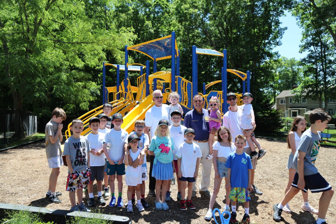 Group standing in front of new playground equipment at Parklet P18 in Old Bethpage